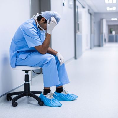Sad surgeon sitting on a chair